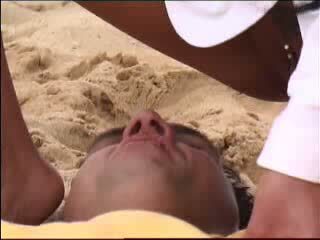 girl temptation makes face sitting on the beach